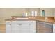 Kitchen sink and dishwasher with white cabinets at 429 Riviera St, Venice, FL 34285