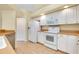 Bright kitchen features white cabinets, modern appliances, and tile flooring at 429 Riviera St, Venice, FL 34285