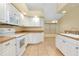 Bright kitchen with white appliances and a cozy breakfast nook at 429 Riviera St, Venice, FL 34285