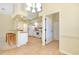 Bright kitchen with white cabinetry and adjacent access to dining area at 429 Riviera St, Venice, FL 34285