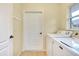 Laundry room featuring a washer and dryer, bright window, and door at 429 Riviera St, Venice, FL 34285