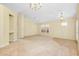 Large living room with carpet, neutral paint, and a large window with wood shutters for ample natural light at 429 Riviera St, Venice, FL 34285