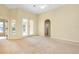 Light-filled living room boasts French doors, neutral walls, and arched doorway at 429 Riviera St, Venice, FL 34285