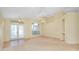 Expansive living room featuring French doors, a ceiling fan, and arched window at 429 Riviera St, Venice, FL 34285