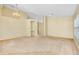 Expansive living area with carpet flooring, ceiling fan, chandelier, neutral paint, and large windows at 429 Riviera St, Venice, FL 34285