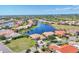 Stunning aerial view of waterfront homes surrounding a large lake in a beautiful, sunny neighborhood at 4403 Via Del Villetti Dr, Venice, FL 34293