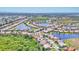 Wide aerial view showcasing the lake community with abundant green spaces, winding streets, and lush landscaping at 4403 Via Del Villetti Dr, Venice, FL 34293