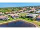Aerial view of the home's backyard and landscaping, situated on a waterfront lot with a community view at 4403 Via Del Villetti Dr, Venice, FL 34293