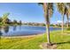 The backyard has mature landscaping and water views at 4403 Via Del Villetti Dr, Venice, FL 34293