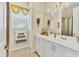 The bathroom has granite countertops and a mirror with attractive lighting, and linen storage at 4403 Via Del Villetti Dr, Venice, FL 34293