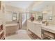 Beautiful bathroom featuring a bathtub, walk-in shower, and double vanity at 4403 Via Del Villetti Dr, Venice, FL 34293