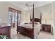 This bedroom offers a four-post bed and a large window to bring in plenty of natural light at 4403 Via Del Villetti Dr, Venice, FL 34293