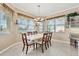 Dining room with a marble table, six chairs, and bright windows at 4403 Via Del Villetti Dr, Venice, FL 34293