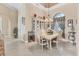 Open dining room featuring elegant furniture, lighting and views to the living area at 4403 Via Del Villetti Dr, Venice, FL 34293