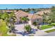 Beautiful single-Gathering home with a tile roof, arched entryway, palm trees, and brick driveway at 4403 Via Del Villetti Dr, Venice, FL 34293