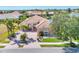 Single-Gathering home with palm trees, lake view, arched entryway, and tile roof at 4403 Via Del Villetti Dr, Venice, FL 34293