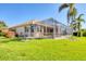 The home features a screened lanai and meticulous landscaping at 4403 Via Del Villetti Dr, Venice, FL 34293