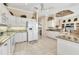Bright kitchen featuring white cabinets, granite counters, and tile flooring at 4403 Via Del Villetti Dr, Venice, FL 34293