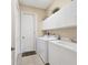 The laundry room has bright storage cabinets, and a utility sink for convenience at 4403 Via Del Villetti Dr, Venice, FL 34293