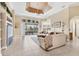 Spacious living room with tile floors, large sliding doors, and elegant furnishings at 4403 Via Del Villetti Dr, Venice, FL 34293