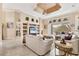 Living room with a view of lanai, built in shelving, tile floor and vaulted ceiling at 4403 Via Del Villetti Dr, Venice, FL 34293