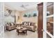 This living room features neutral tones, decorative curtains, and lots of natural light at 4403 Via Del Villetti Dr, Venice, FL 34293