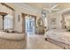 Main bedroom with a ceiling fan, seating area, and patio access at 4403 Via Del Villetti Dr, Venice, FL 34293