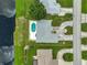 Birds eye view of property showcasing layout of yard, pool, nearby waterway and proximity to neighborhood road at 447 Rotonda Cir, Rotonda West, FL 33947