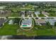 Aerial view of neighborhood with circle around a property showcasing pool, circular driveway, and nearby waterway at 447 Rotonda Cir, Rotonda West, FL 33947