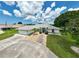 Aerial shot showcasing a well-maintained home with lush landscaping and a spacious driveway at 447 Rotonda Cir, Rotonda West, FL 33947