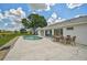 The house offers a backyard with a pool, a patio, and a lush green landscape at 447 Rotonda Cir, Rotonda West, FL 33947