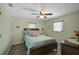 Bedroom featuring wood floors, a ceiling fan, and natural light at 447 Rotonda Cir, Rotonda West, FL 33947