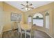 Bright dining room with wood floors, ceiling fan, and traditional dining set at 447 Rotonda Cir, Rotonda West, FL 33947