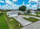Aerial view showcasing a home with a circular driveway, well-kept lawn, and a two-car garage at 447 Rotonda Cir, Rotonda West, FL 33947