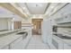 Modern kitchen with white cabinetry, stainless steel appliances, and a view into the dining and living areas at 447 Rotonda Cir, Rotonda West, FL 33947