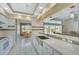 Bright kitchen with stainless steel appliances, white cabinetry, and a breakfast bar, perfect for entertaining at 447 Rotonda Cir, Rotonda West, FL 33947