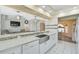 Beautiful kitchen with granite countertops, modern lighting, stainless steel sink, and views into the living areas at 447 Rotonda Cir, Rotonda West, FL 33947