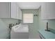 Laundry room with white cabinets, a counter, and newer appliances at 447 Rotonda Cir, Rotonda West, FL 33947
