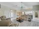 Comfortable living room with tile and wood flooring, neutral decor, and a view into the dining area at 447 Rotonda Cir, Rotonda West, FL 33947