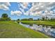The property offers a tranquil water view surrounded by lush greenery and clear skies at 447 Rotonda Cir, Rotonda West, FL 33947