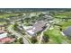Aerial view of the clubhouse, pool, tennis courts, golf course, and lake at 4532 Chase Oaks Dr, Sarasota, FL 34241