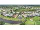 Aerial view of a golf course community with a lake and single Gathering homes at 4532 Chase Oaks Dr, Sarasota, FL 34241