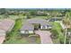 Aerial view of the single Gathering home with tile roof, decorative landscaping, and brick paver driveway in a golf community at 4532 Chase Oaks Dr, Sarasota, FL 34241