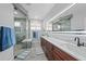 Modern bathroom featuring double vanity, glass shower, and light grey tiling at 4532 Chase Oaks Dr, Sarasota, FL 34241