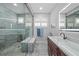 Bright bathroom features a glass shower with seat, window shutters, and stone floors at 4532 Chase Oaks Dr, Sarasota, FL 34241