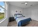 Bedroom with blue bedding, two end tables, and luxury vinyl plank flooring at 4532 Chase Oaks Dr, Sarasota, FL 34241