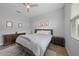 Cozy bedroom with a neutral color scheme and wood-look laminate floors at 4532 Chase Oaks Dr, Sarasota, FL 34241