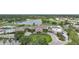 Stunning aerial view of the clubhouse, swimming pool, and parking area at 4532 Chase Oaks Dr, Sarasota, FL 34241