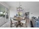 Dining area featuring modern lighting, a round wooden table, and access to the outdoor living space at 4532 Chase Oaks Dr, Sarasota, FL 34241