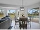 Charming dining area with a round table, bay window, and views of the pool and landscaped yard at 4532 Chase Oaks Dr, Sarasota, FL 34241